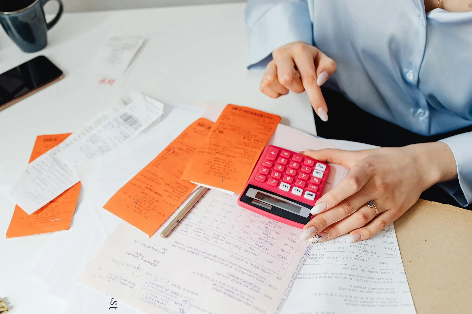 Tax paperwork, receipts, and forms organized on a desk for filing