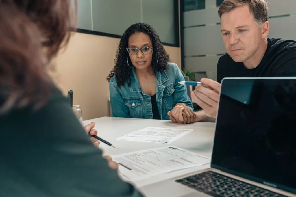 A South Florida couple reviewing health insurance paperwork at home as 2026 marketplace premiums rise
