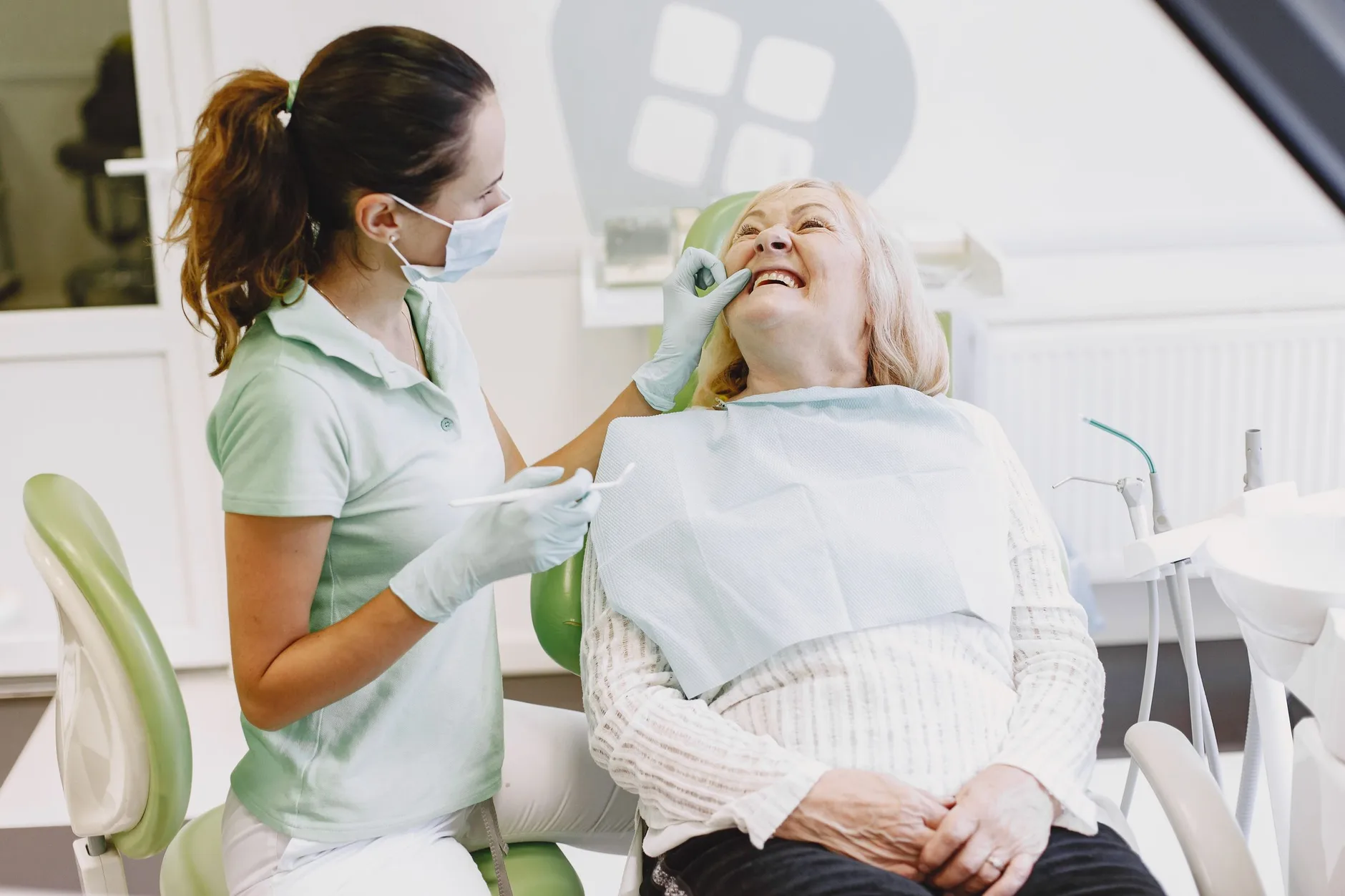 An older woman at a dental check-up, the kind of visit a Medicare Advantage dental benefit is meant to cover